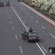 Having reached the end of the military portion of the parade, Xi circles back. Xi does not have a license plate.